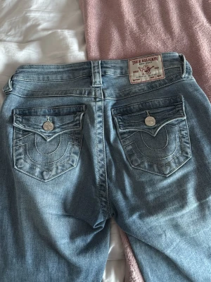 Ljusblåa True religon jeans - Sååå snygga true religon jeans i storleken w25 i modellen Becca. Jeansen har inga som helst defekter utom en liten liten fläck längst ner som inte alls märks. Jeansen sitter ganska bra på mig som har storlek 34/s i jeans, men jeansen kan även passa större och mindre storlekar eftersom de är stretchiga. Pris kan diskuteras 😊. Hör av dig vid några frågor eller funderingar!☺️💕(lånad bild!)