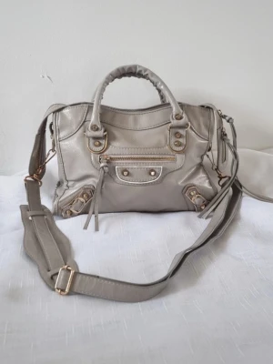 Grå beige axel/handväska med gulddetaljer - Kan posta snabbt och pris kan diskuteras. Skriv gärna vid frågor och funderingar!