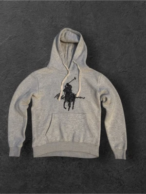 Grå Ralph lauren hoodie storlek M - Tja! Nu säljer jag denna riktigt feta och sköna Ralph lauren hoodien då jag inte använder längre. Den är i super skicka och helt redo för att användas av någon annan. Storlek M och ett fett märke på bröstet. Om ni har minsta funderingen så är det bara o skriva!