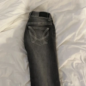 Gråa bootcut jeans från Gina Tricot - Snygga grå bootcut jeans från Gina Tricot i modellen Perfect Jeans. Jeansen har markerade vita sömmar, klassiska fickor fram och bak samt låg midja. Materialet är jeans och passformen är normal. Använda endast 1 gång