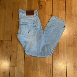Ljusblå flared  jeans från Dondup, storlek 27 - Säljer ett par ljusblå jeans från Dondup i klassisk femficksmodell. Använd enstaka gånger, pris kan diskuteras, ordinarie pris ca 3000 kr