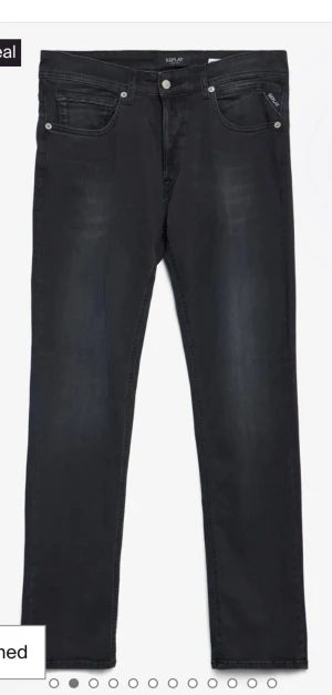 Replay svarta jeansbyxor straight fit - Svarta jeansbyxor från Replay med klassisk femficksdesign och subtila slitningar. Modellen har rak passform och normal midja, med snygga detaljer vid fickorna och knappstängning framtill. Perfekt för dig som gillar stilrena och tidlösa jeans. Köpta på jeansbolaget, kvitto medföljer 