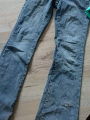 Blå jeansbyxor XS med dubbla knappar - Fina jeans i strlk 36. Mellan midjad. Inte låga men inte höga. Använd ca 2 ggr Inga slitage  150kr+frakt