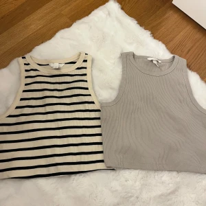 4-pack ribbade linnetoppar H&M M - Fyra croppade ribbade linnetoppar från H&M i storlek M. En beige med svarta ränder, en helgrå, en knallrosa och en vit. Alla har breda axelband och rund halsringning, perfekta för en chill och trendig look. Alla är storlek M men passar även dom som är en S skulle ja säga. Kan sälja separat om de önskas ☺️