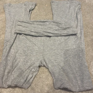 Grå mjukisbyxor i bomull, stl 160 - Grå mjukisbyxor i mjukt och stretchigt bomullsmaterial. Byxorna har en enkel och avslappnad passform med resår i midjan. Perfekta för chill dagar hemma eller när du vill vara extra bekväm. Färg: ljusgrå.