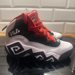  FILA MB Mashburn Basketball - Säljer ett par feta Fila sneakers i high-top modell med svart, vit och röd färg. Skorna har coolt grafiskt mönster på sulan, röd mesh och snörning, samt Fila-logga broderad på tungan och hälen. Ovandelen är i syntet och skinn för extra hållbarhet. Nypris 1400:-