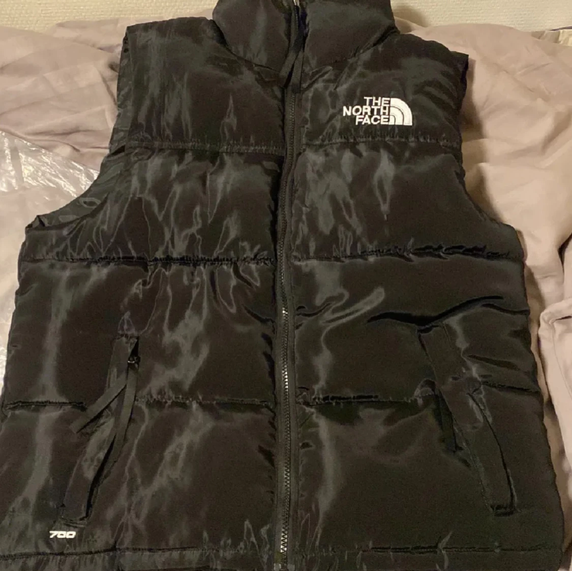 Svart dunväst från The North Face