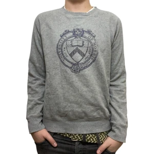 Grå Morris tröja - Grå sweatshirt från Morris Gents med mörkblå universitetsinspirerat tryck på bröstet. Rund halsringning, ribbade muddar och långärmad. Mjuk insida och klassisk passform, perfekt för chill dagar. Storlek S.