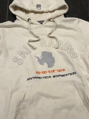 Sail Raicing Hoodie Retro Archive  - Tjena säljer denna tvärfeta hoodien från sailracing i storlek S. Riktigt unik och fin modell som passar pertekt for Stockholm/ archive stilen. Finns bara en liten gul knappt synlig missfärgning på högra ficken. Går sakert bort med vanish eller tvatt, har inte testat nåt av det. Skriv gärna vid intresse.