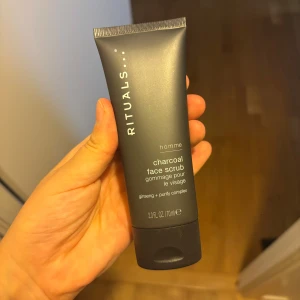 Rituals Charcoal Face Scrub Homme - Rituals Homme Charcoal Face Scrub med ginseng och purify complex. Tuben är mörkgrå och rymmer 70 ml. Ansiktsskrubben innehåller 98% ingredienser av naturligt ursprung och är framtagen för att rengöra och exfoliera huden med kol och växtextrakt. Helt ny aldrig använd 