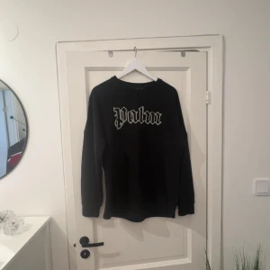 Svart Palm Angels sweatshirt - Svart sweatshirt från Palm Angels med logotyptext 'Palm' på framsidan och 'Angels' på baksidan