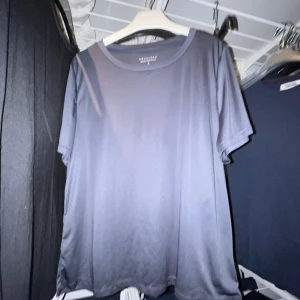 Mörkgrå t-shirt från Brisilen - En enkel och stilren mörkgrå t-shirt från Brisilen. Modellen har rund hals och korta ärmar, perfekt för en clean och avslappnad look. Materialet känns mjukt mot huden och passformen är normal. Snygg att matcha med jeans eller shorts.
