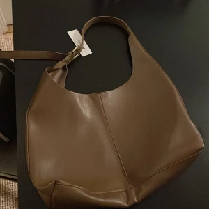 Brun axelväska från Gina Tricot - Helt ny brun axelväska från Gina Tricot. Ny med prislapp. Pris kan diskuteras