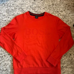 Hugo boss sweat shirt - Hugo Boss Sweatshirt – Orange 👕 Storlek: L (kan justeras om du har annan storlek) ✨ Skick: 9/10 – sparsamt använd, i mycket fint skick 🧡 Färg: Orange – sticker ut på rätt sätt 💎 Märke: Hugo Boss