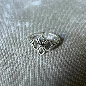 Ciel de Fleur  - A modern, airy take on the Fleur de Lis. Adjustable, unisex, and versatile