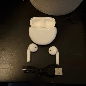 Vita trådlösa hörlurar med laddsladd - Väldigt nya och använda en gång så minimalt till inget slitage. Bra ljud, usb-c laddare för hörlurarnas usb-c uttag.