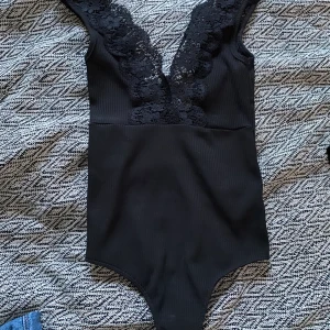 Body med djup rygg och spets - Strl xs/s, svart body med djup rygg. Är använd rätt mycket förut men är i superfint skick fortfarande. Köptes för typ 300kr på bikbok. Säljer för 60kr (+frakt)💓🛍