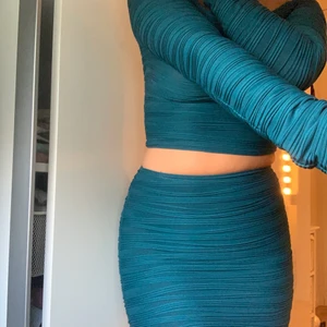 Turkost set - Snyggt set i en turkosaktig färg, i storlek XS. Toppen är långärmad och offshoulder och kjolen slutar precis ovanför knäna. Över/underdel kan även köpas separat om så önskas. 25kr styck.💙