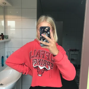 Snygg croppad röd hoodie - Jättecool röd hoodie med tryck! Storlek XS/34. Säljer pga att den sällan kommer till användning. Köparen står för frakten och jag vet att den är dyr, därför är priset på plagget sänkt!