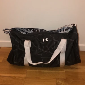 Under armour väska - Jättecool väska från Under Armour som rymmer mer än man tror. Väskan är aldrig använd så i väldigt bra skick! Jättebra som skolväska eller när man ska iväg. Nypris är 340kr men säljer för 150kr+frakt!