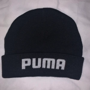 Puma mössa - Svart vanlig puma mössa, aldrig använt, finns i Halmstad men går att fraktas