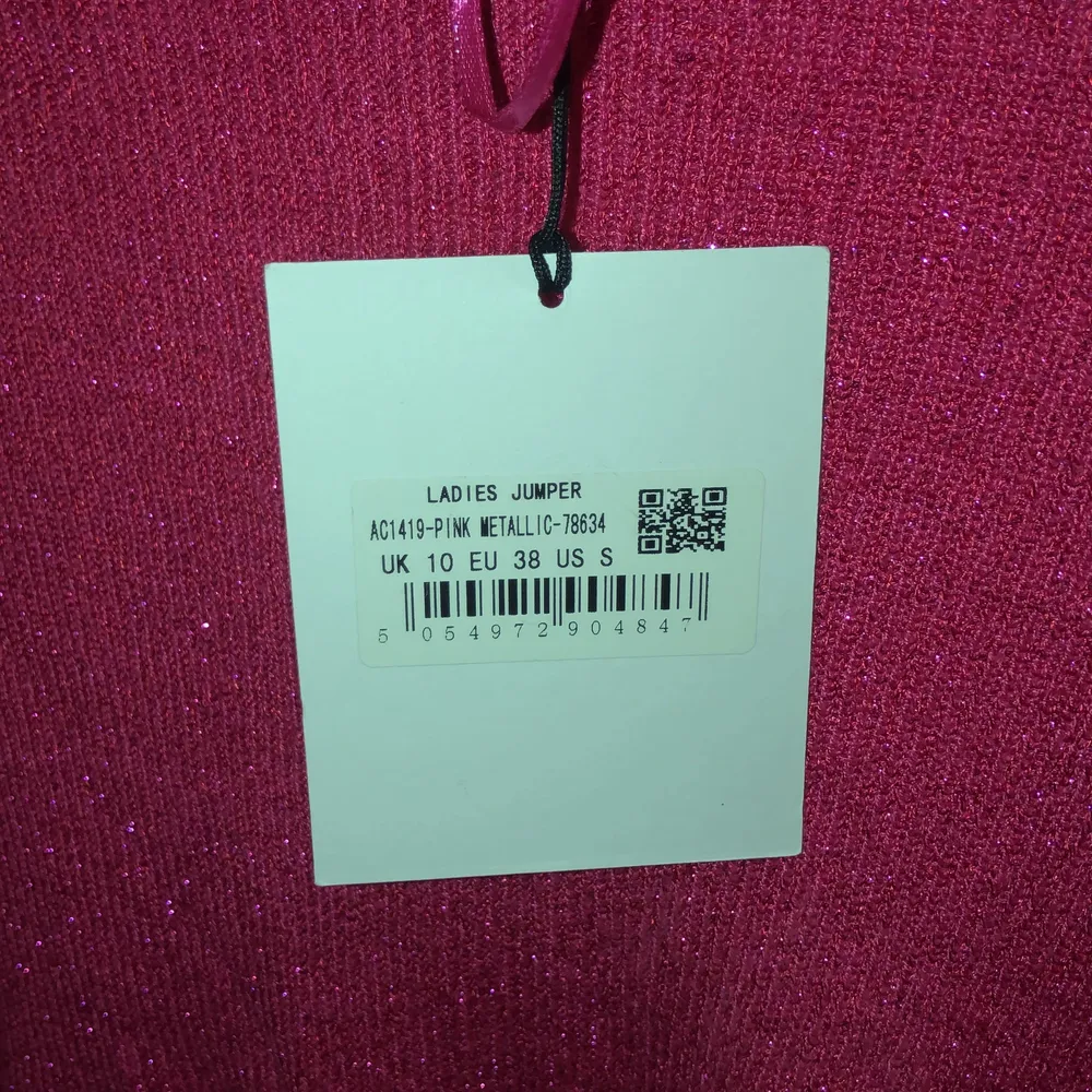 Stickad glittrig rosa tröja. Storlek EU 38 så passar medium/small. Helt oanvänd. Toppar.