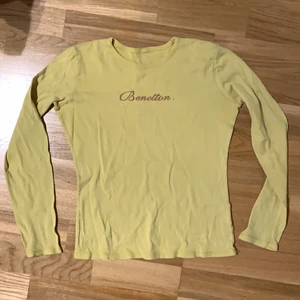 Långärmad benetton tröja - Gul tröja med rosa tryck från Benetton, köpt second hand, använd sällan, har en perfekt länd ner till början av höfterna, kontakta om mer info🥰