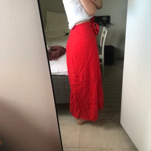 Omlottkjol - Superfin röd omlottkjol ifrån hm. Skrynklig på bilderna men går lätta att stryka. Den har även på knappar på insidan vilket hindrar att den låstnar och gör den mer säker. Så fin att ha när man blivit lite brun. Kom privat för frågor💙💙