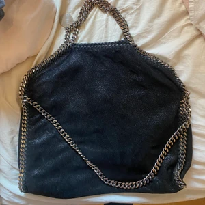 Stella McCartney  - Säljer denna jätte fina Stella McCartney väskan. Den är mellan storleken och perfekt för att ha över axeln. Några år gammal och den är lite sliten. Inget som syns när man använder den men inuti är det lite slitet. Se bild 3. Jätte fin annars och en super bra rymlig väska. Priset kan diskuteras vid snabb affär 