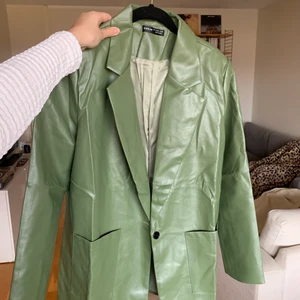 Skinnjacka - Skinnjacka (inte äkta) som aldrig är använd därför är den rynkig från frakten. Skitsnygg grön färg men har inte användning av den längre. Sitter Oversized på mig som har M men skulle passa så på S också och lite mer fitted på L!💕 Jag står för frakt om varan överstiger utropspriset!😊 Köpt för 259kr.