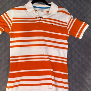 Randig Tommy hilfiger tröja strl 164 - Ska sälja min Tommy holfiger ”golf tröja” som jag köpte 2019. Dessa tröjor var väldigt trendiga runt 2019 och då köpte jag den på emmaus secondhand för 200kr. Tröjan är i väldigt bra skick för att ha varit begangnat två gånger! Jag säljer tröjan för att jag aldrig har på mig den längre. Den är egentligen för pojkar strl 164, men vem som helst kan använda den. Där är lite baggy, så jag slutade dne med ett par blåa baggy byxor och lite smycken. Man kan också had en under en sweater💗💗😚