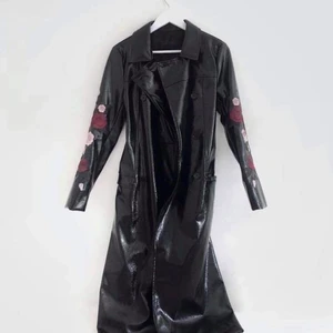 Läderkappa från NAKD i storlek 36 - Cool och trendig läderkappa i skinnimitation från NAKD med lång design samt detalj. Storlek 36/S. Kappan är knappt använd, i nyskick. Etiketter saknas.                         Frakt: står köparen för, spårbar genom PostNord. 