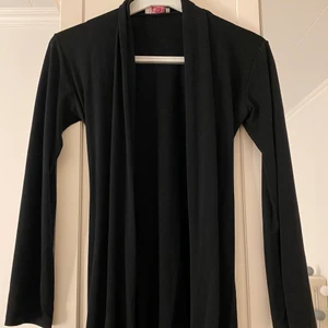 Svart kofta - En enkel svart kofta, har en jättebra passform, är i väldigt bra skick, har en band där bak så man kan knyta. 