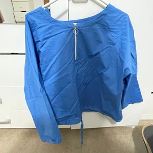 Tröja  - Blå tröja med snöre nere och lite vida ärmar 