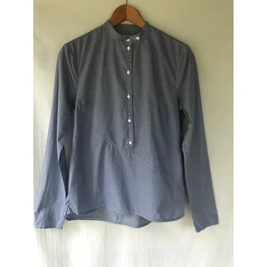 Baum und Pferdgarten blå blus vita knappar  - Baum und Pferdgarten Blå blus i bomull med vita knappar. storlek 34 (små i storlek) Fint skick och sparsamt använd  Längd: 63cm Material: 100% bomull