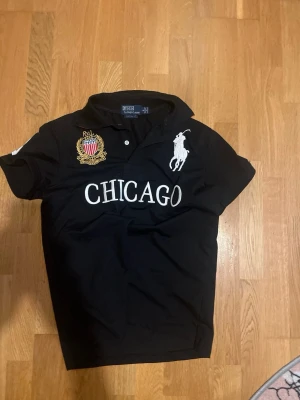 Polo Ralph Lauren "Chicago" Big Pony Polo - Size S - Selling a like-new Polo Ralph Lauren Custom Fit polo shirt.  Size: S  Color: Black with white and red details  Condition: Flawless / Like New (10/10)  Details: Features the classic white Big Pony, detailed Chicago crest, and #3 patches on the back and sleeve. Feel free to ask for measurements. Fast shipping! 📦  #poloralphlauren #ralphlauren #bigpony #chicago #customfit #likenew