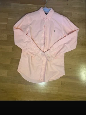 Rosa Ralph Lauren skjorta  - En rosa skjorta från Ralph Lauren i jätte fint skick, Storlek M och de är slimfit, hör av dig vid frågor 