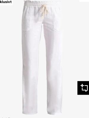 Vita Roxy linnebyxor - Snygga vita linnebyxor med avslappnad passform och snöre i midjan. Byxorna har utsvängda ben, två framfickor och är tillverkade i ett lätt och luftigt linnetyg. Perfekta för en chill och stilren look.