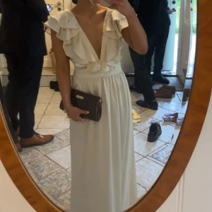 Champagnefärgad långklänning med volangdetaljer - Champagnefärgad balklänning med djup v-ringning och volangdetaljer. Köpt här på Plick (inte mina bilder) men säljer då jag har köpt en annan🥰