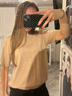 Beige kortärmad stickad topp - Stilren beige topp med korta ärmar och rund hals. Inga synliga skador!!💖💖💖
