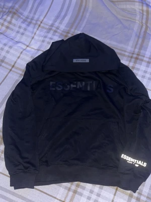 Svart Essentials Fear of God hoodie - Svart essentials hoodie med reflex på texten på armen riktigt fet hör av dig vid frågor!