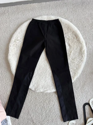 Svarta leggings (XS) - Säljer ett par svarta leggings med detaljer längs benen 