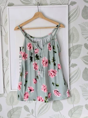 Linne Bodyflirt Storlek 36/38 (38-40) - -Jättesnygg skön och elastiskt linne ifrån Bonprix märke Bodyflirt..  - Storlek 36/38 men jag skulle rekomendera den till en stl 38/40.  - Avslappnat linne som inte sitter åt.  - Är lite missvisande färg på bilderna själva bakgrundsfärgen är som ljus pastellgrön.  - Oanvänd.  - Jag kan ha missat någon miniskavank men jag har försökt att granska så gott det går..