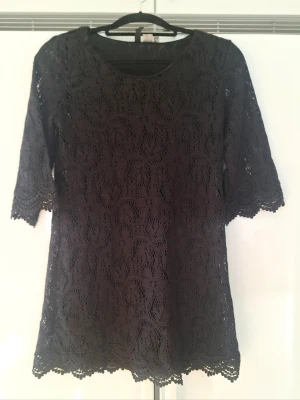 Svart spetsklänning/ tunika från Divided - Säljer en svart A-linje tunika/klänning från Divided i storlek 38. Innerklänning. 