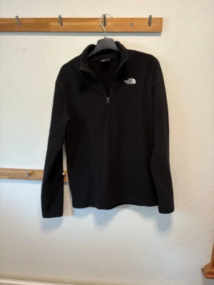 The North Face Quarter Zip - Quarter zip från The North Face i fleecematerial. Extremt skön att ha på sig. Storlek XL barn vilket motsvarar ca xs/s. Väldigt lite använd därför väldigt fint skick