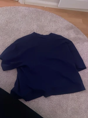 Mörkblå basic t-shirt - En enkel mörkblå t-shirt med normal passform och korta ärmar. Perfekt till jeans eller shorts för en clean och stilren look. Tillverkad i mjukt bomullsmaterial som känns skönt mot huden.