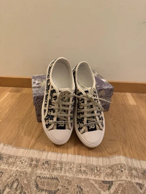Dior sneakers - Säljer nu mina as snygga svarta Walk’N’Dior sneakers i väldigt fint & sparsamt skick, då de ej kommer till användning. Tillbehör medkommer. Pris är diskuterbart!