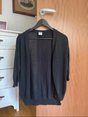 Svart glittrig kofta i storlek M - Svart glittrig kofta i storlek M från vero Moda. Mycket bra skick!