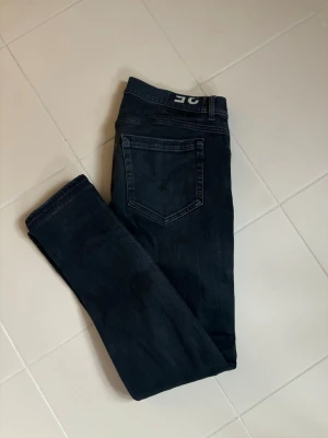 Dondup George jeans w35 svart - Svarat stentvättade snygga populära trendiga Dondup George jeans i w35 säljes. 45 cm breda och 103 cm total längd. Inga hål eller fläckar i grymt skick verkligen! Sjukt snygga på, grym passform och jättefina perfekta nu till våren!