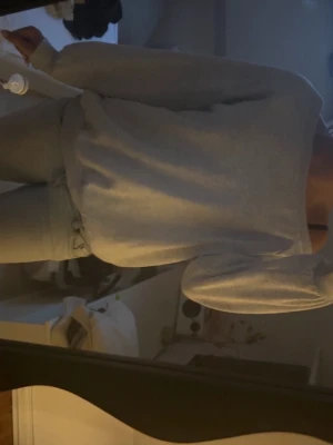 Ljusgrå basic sweatshirt - En enkel och stilren ljusgrå sweatshirt med rund hals och långa ärmar. Tröjan har en avslappnad passform och ribbade muddar vid ärmslut och nederkant. Perfekt för en chill och bekväm look.